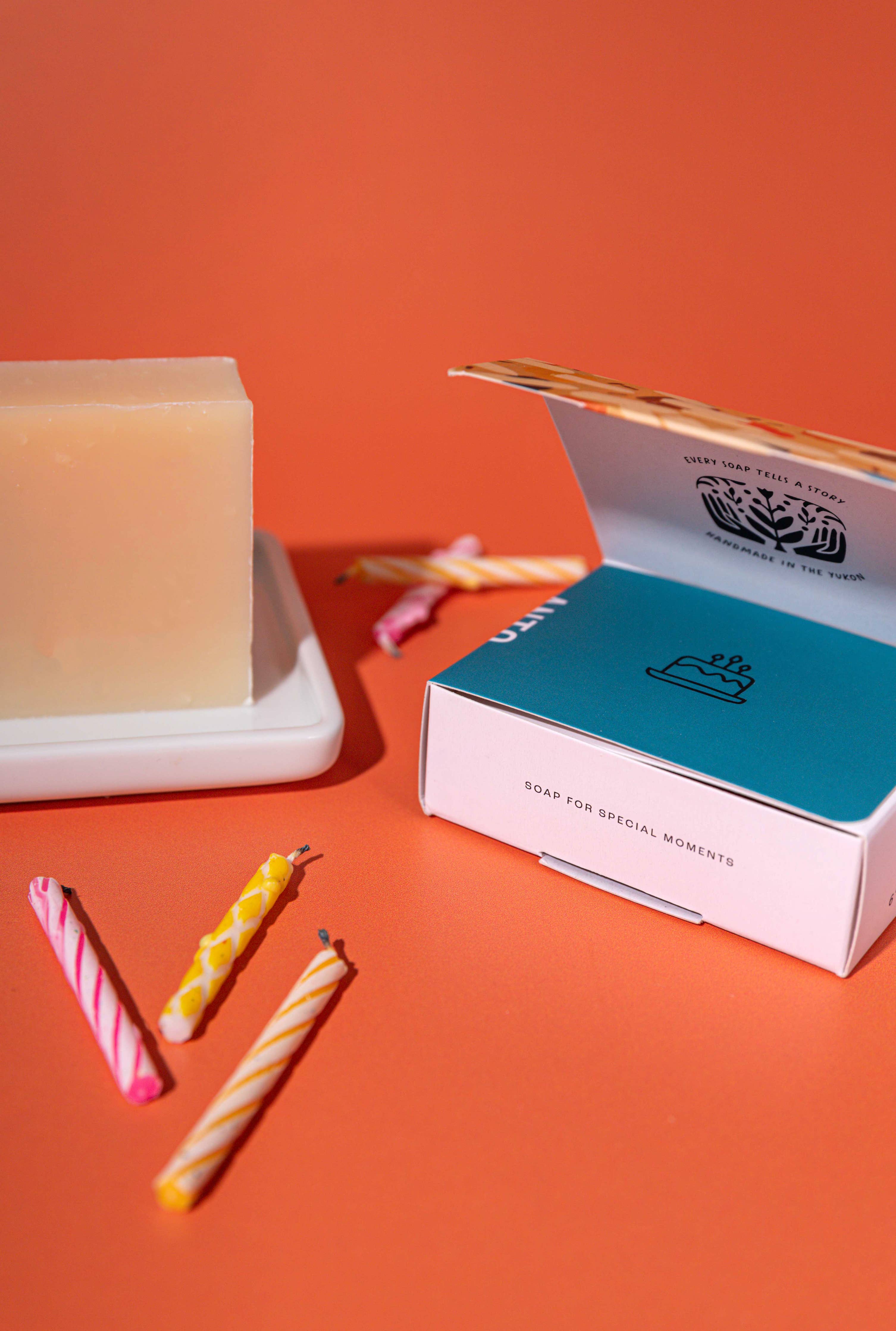Candle and packaging on an orange background