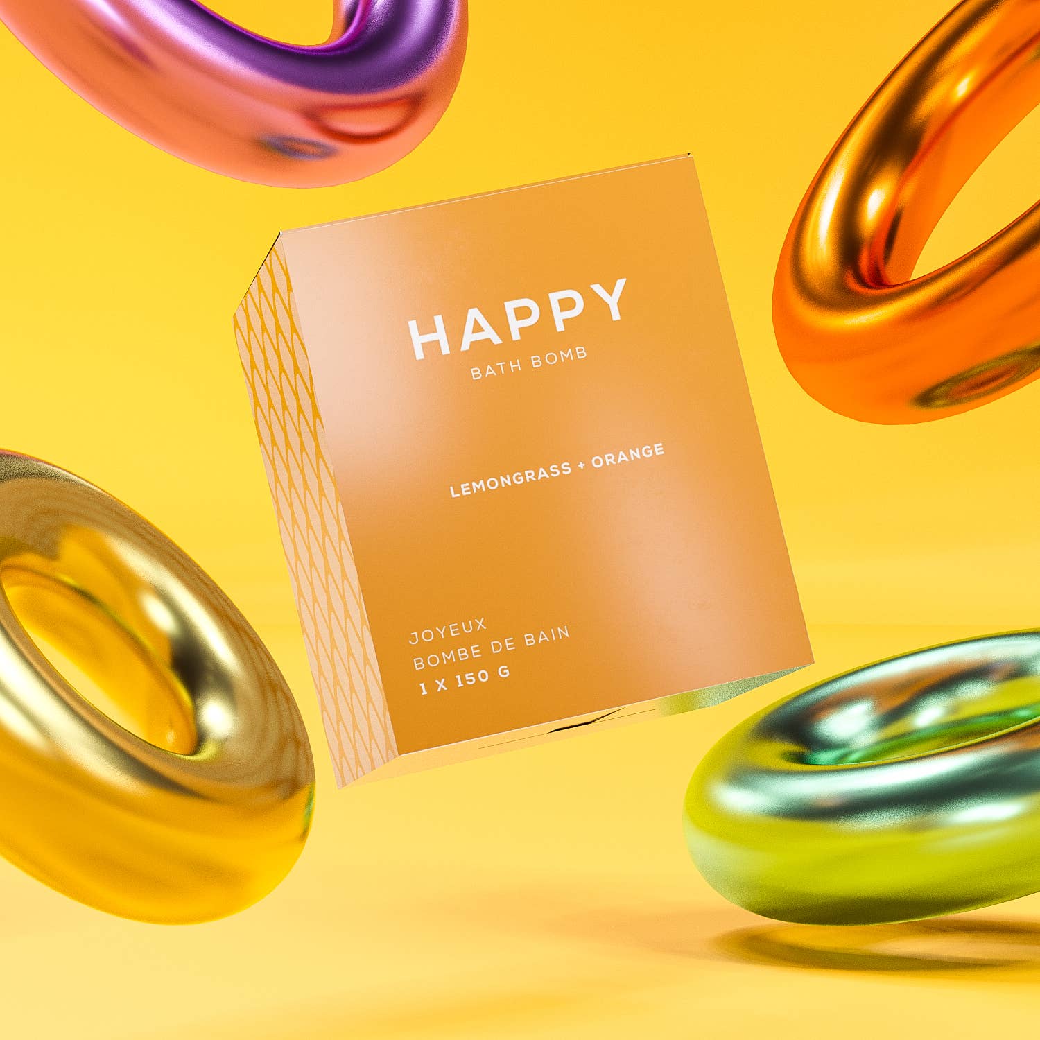 Orange 'Happy' bath bombs box with colorful metallic rings on a yellow background