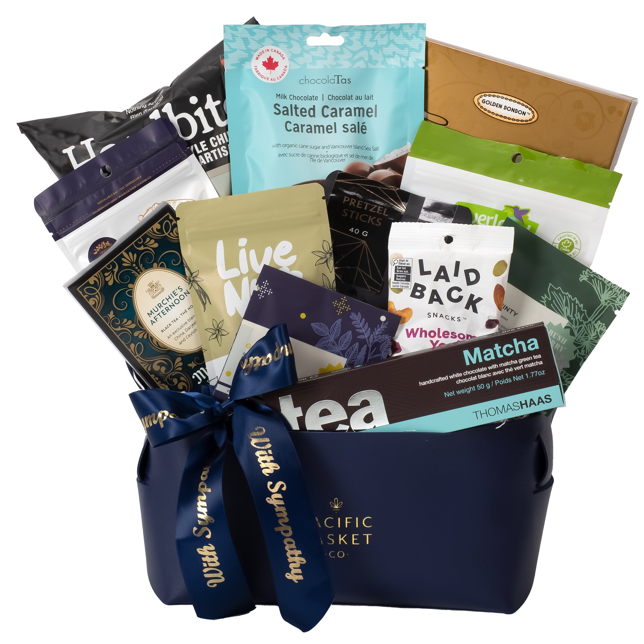 Assorted snacks and tea packages in a navy blue basket with visible branding.