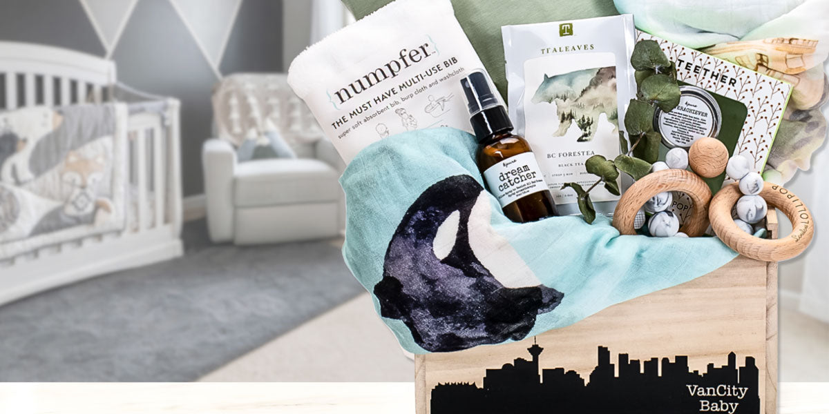 Vancouver baby gift basket with plush toy, bottle, and other items in a wooden box.