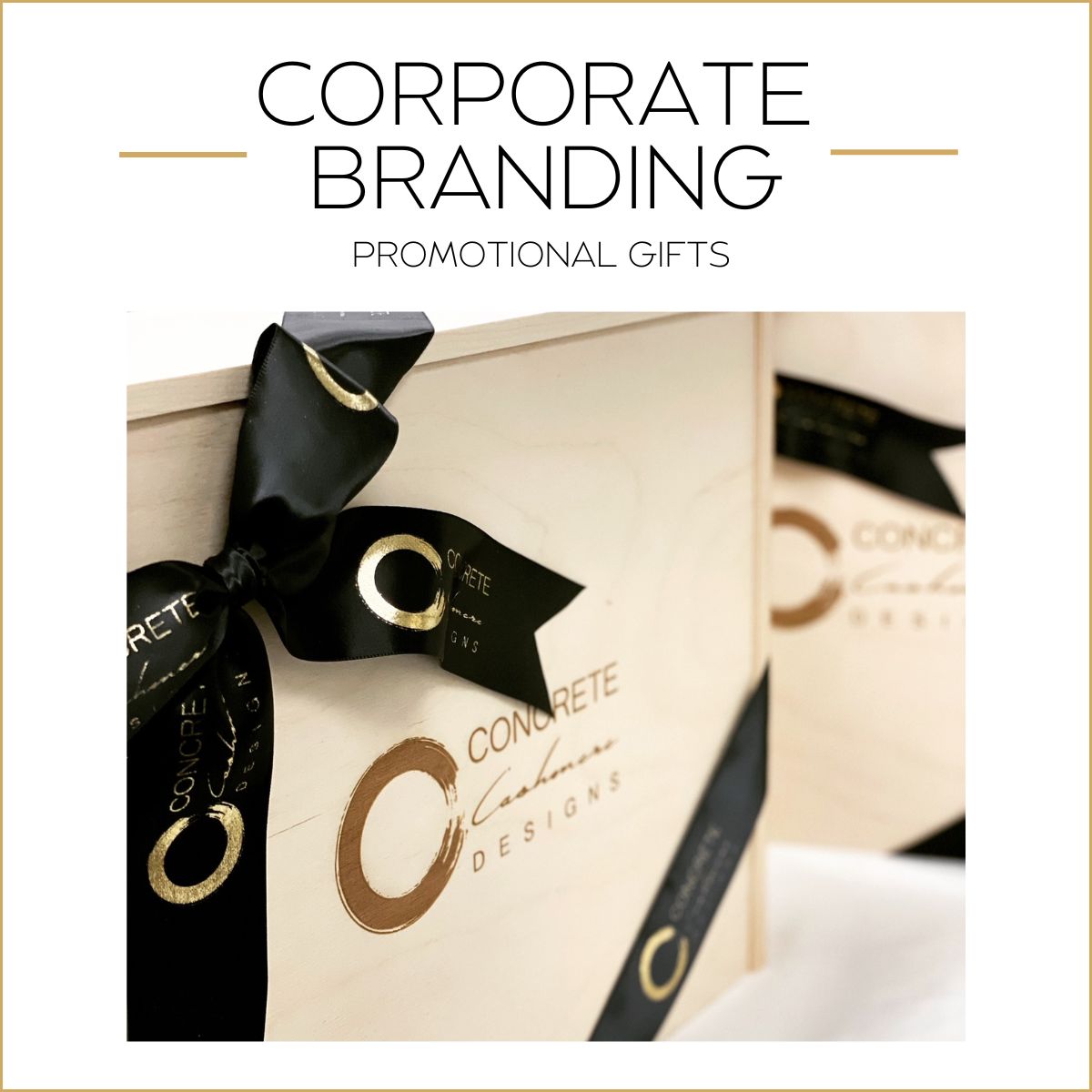 Promotional gift box with black ribbon and corporate branding on a white background