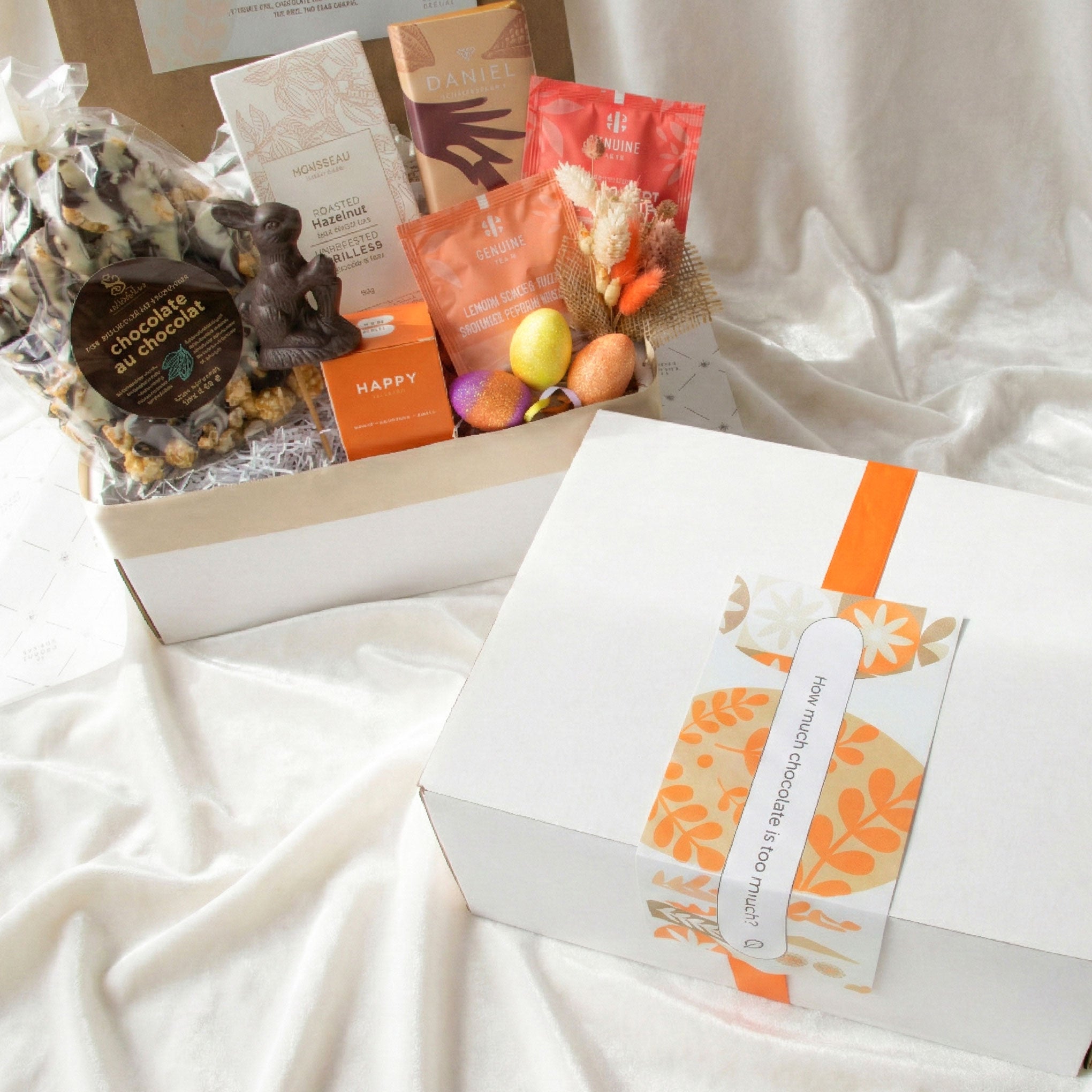 Easter bunny gift box surrounded by chocolate bars and popcorn for the inside of a gift box lid.