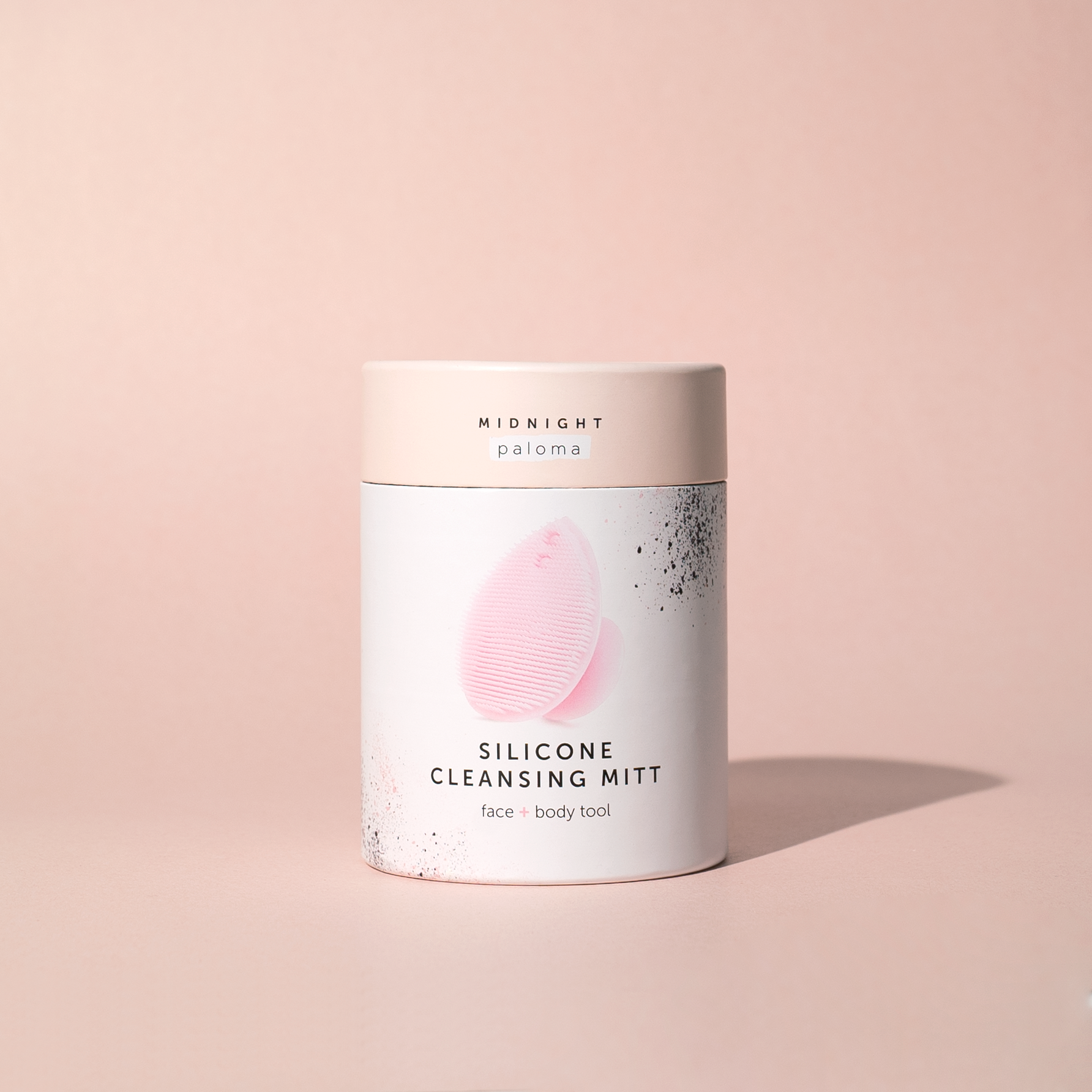 Silicone cleansing mitt packaging on a beige background