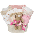 Baby gift basket with plush toy, clothes, and blankets on a white background