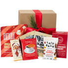 Assorted snack packages in front of a gift box with a red ribbon. Gift box Vancouver