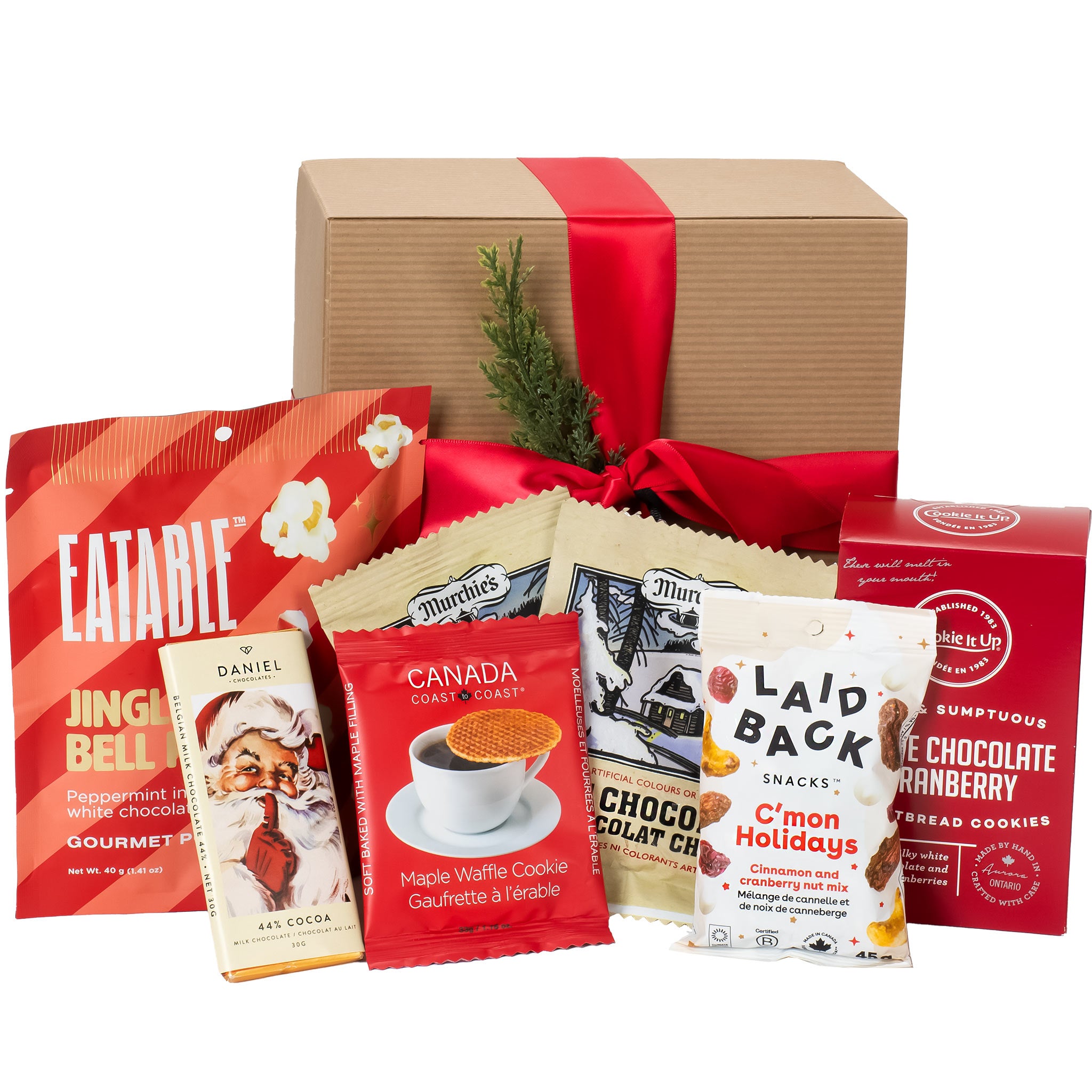 Assorted snack packages in front of a gift box with a red ribbon. Gift box Vancouver