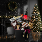 Assorted snack bags in a black box with Christmas decorations in the background