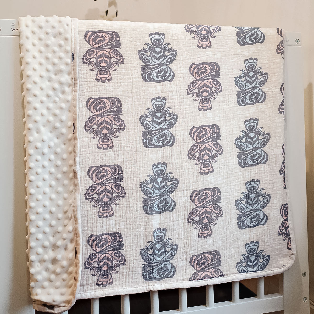 Canadian Indigenous baby blanket by Native Northwest. Showcasing design by Indigenous artist Yasakw (Shelly Samuels) . Shipping across Canada. 