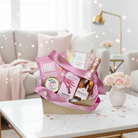 Gift basket with pink ribbons on a table in a living room setting
