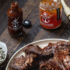 Meat dish with Saltspiring Kitchen Co. products on a wooden surface