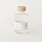 Bottle of Sealuxe lemon lavender bubble bath with wooden cap on a white background 