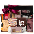 Assorted gourmet snacks including Daniel chocolates, Klondike kettle corn, and Hardbite chips in a gift box.