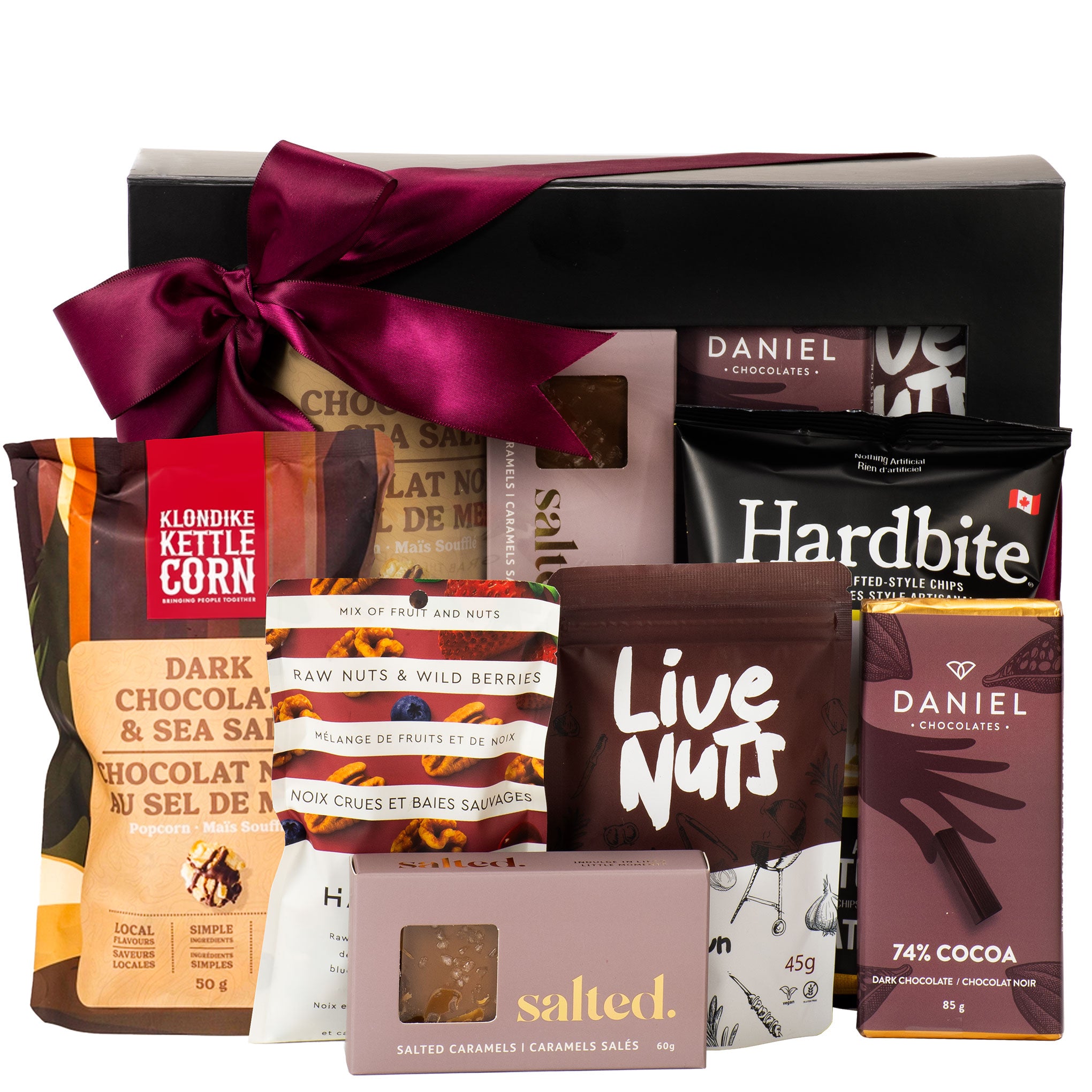 Assorted gourmet snacks including Daniel chocolates, Klondike kettle corn, and Hardbite chips in a gift box.