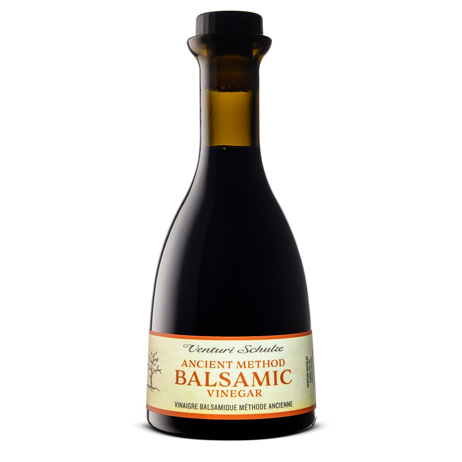 Bottle of balsamic vinegar with a label on a white background