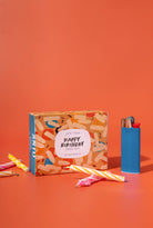 Gift box with 'Happy Birthday' label on an orange background