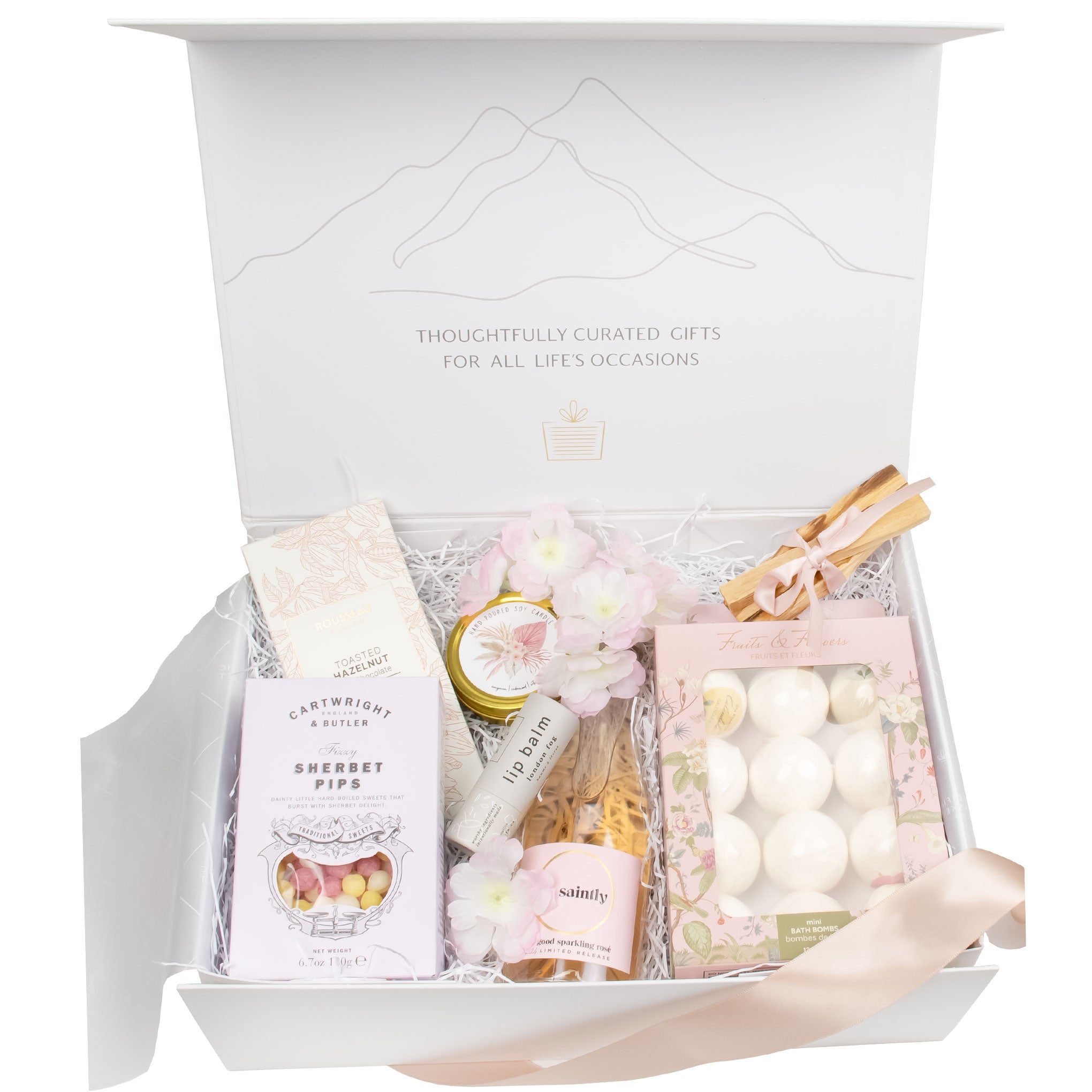 A detailed close-up of the Blooms and Bubbly luxury self-care gift, showcasing the botanical spa basket essentials like the Palo Santo bundle, artisan candle, and bubbly gift set - a sophisticated alternative for a Mother’s Day gift basket.